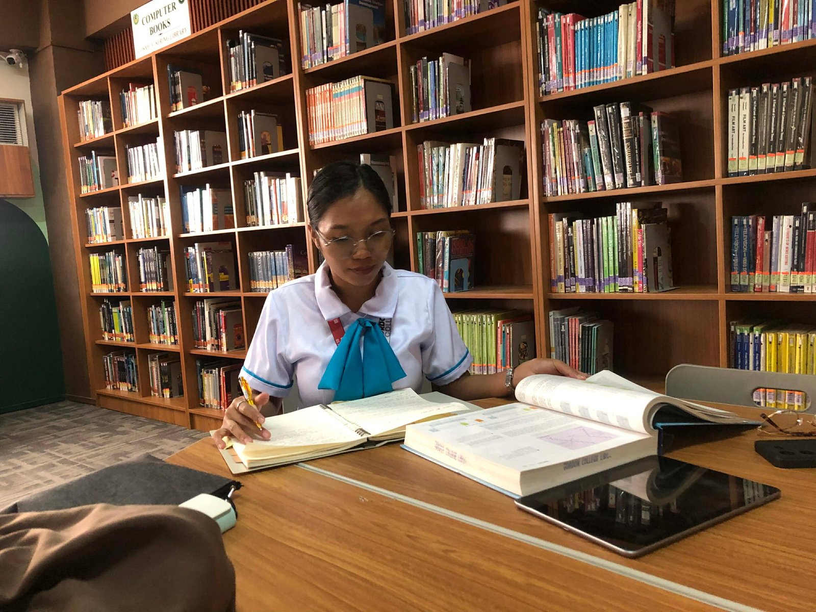 Mariel studying in library